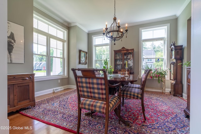 26 Galleon Dr Unit 26, Malta, NY 12020 - dining space featuring a chandelier, wood finished floors, baseboards, and ornamental molding