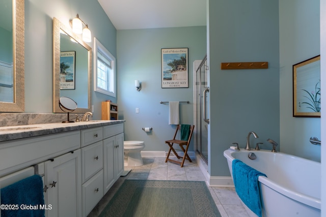 26 Galleon Dr Unit 26, Malta, NY 12020 - bathroom with double vanity, a soaking tub, a shower stall, toilet, and baseboards