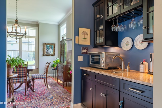 26 Galleon Dr Unit 26, Malta, NY 12020 - indoor dry bar featuring crown molding, a chandelier, decorative light fixtures, and baseboards
