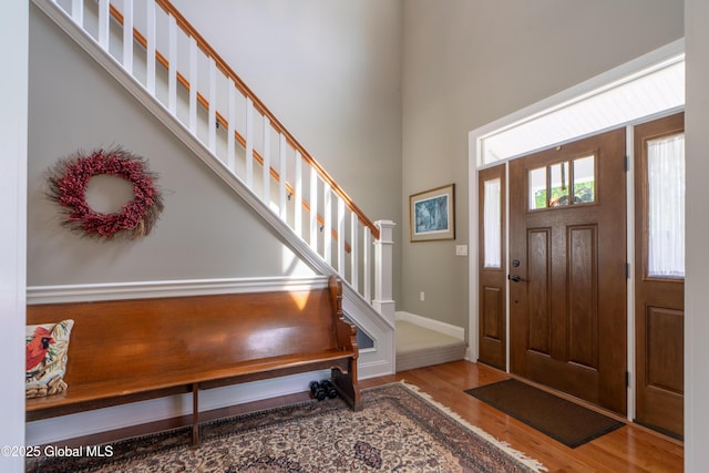26 Galleon Dr Unit 26, Malta, NY 12020 - entrance foyer with wood finished floors, a high ceiling, stairs, and baseboards