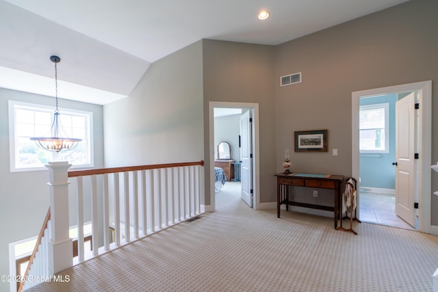 26 Galleon Dr Unit 26, Malta, NY 12020 - corridor with a chandelier, vaulted ceiling, carpet floors, and baseboards