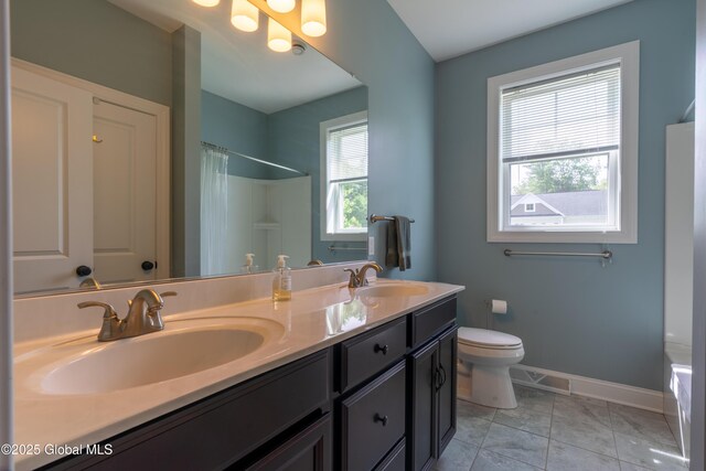 26 Galleon Dr Unit 26, Malta, NY 12020 - full bathroom with double vanity, toilet, baseboards, a shower with curtain, and a bathtub