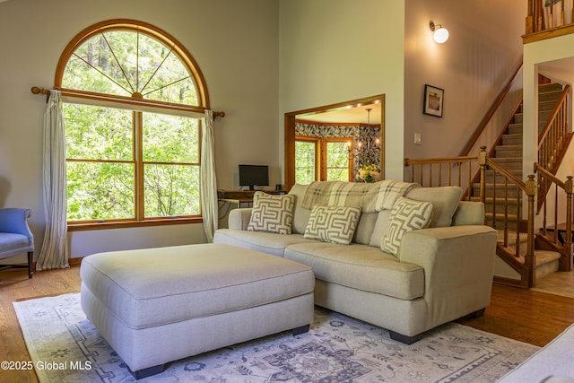 844 Red Oak Dr, Niskayuna, NY 12309 - living room featuring a towering ceiling, wood finished floors, a chandelier, and stairway