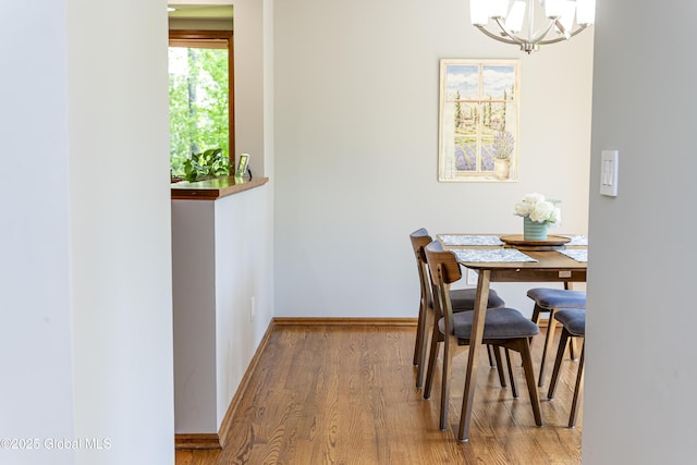 844 Red Oak Dr, Niskayuna, NY 12309 - dining room featuring a chandelier, wood finished floors, and baseboards