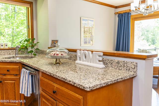 844 Red Oak Dr, Niskayuna, NY 12309 - kitchen with a sink, a chandelier, brown cabinetry, dishwasher, and light stone countertops