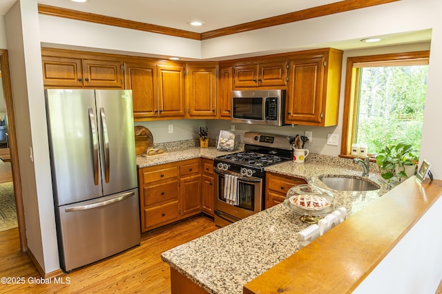 844 Red Oak Dr, Niskayuna, NY 12309 - kitchen featuring appliances with stainless steel finishes, a sink, light wood-style floors, light stone countertops, and recessed lighting