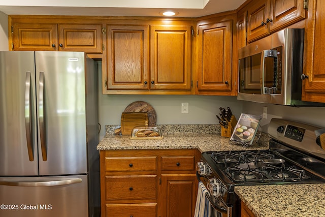 844 Red Oak Dr, Niskayuna, NY 12309 - kitchen featuring appliances with stainless steel finishes, brown cabinets, light stone counters, and recessed lighting