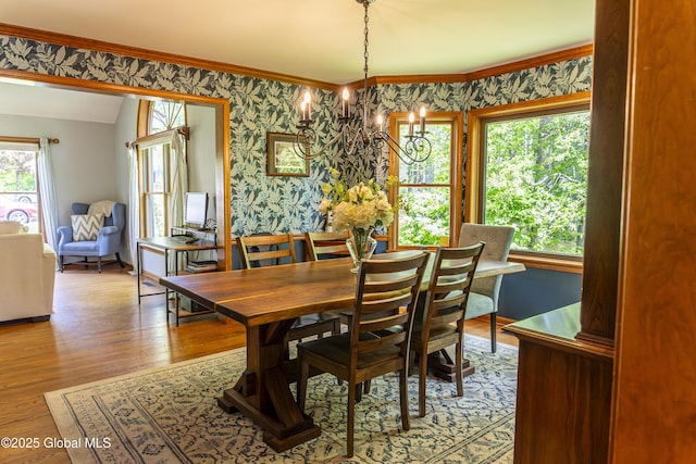 844 Red Oak Dr, Niskayuna, NY 12309 - dining space featuring wallpapered walls, a chandelier, wood finished floors, and ornamental molding