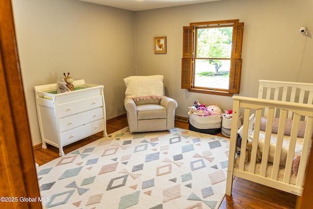 844 Red Oak Dr, Niskayuna, NY 12309 - bedroom featuring wood finished floors, a crib, and baseboards