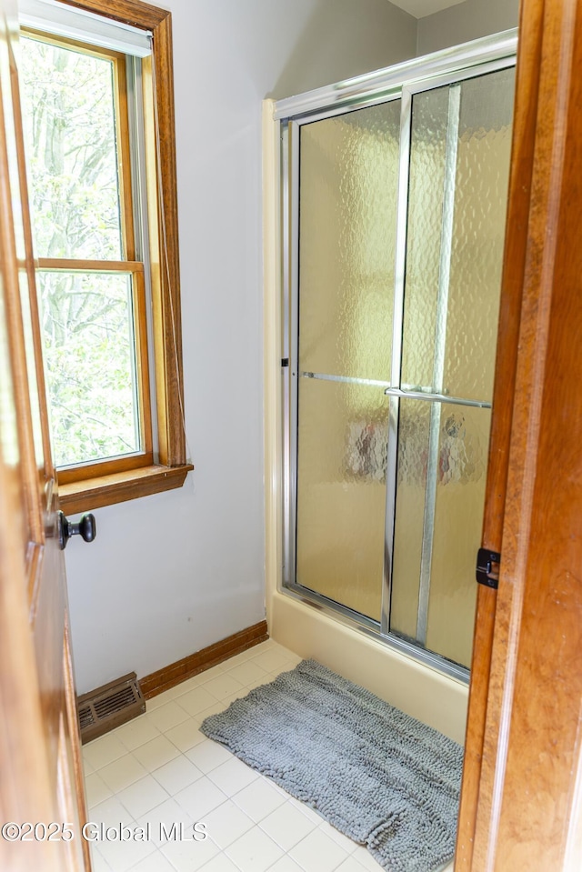 844 Red Oak Dr, Niskayuna, NY 12309 - full bath featuring a shower with door, tile patterned floors, and baseboards
