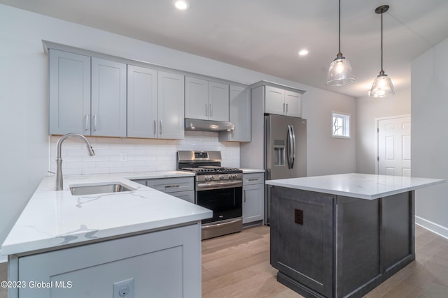 16 Priddle Ln, Colonie, NY 12110 - kitchen featuring gas range, under cabinet range hood, a sink, decorative backsplash, and light wood finished floors