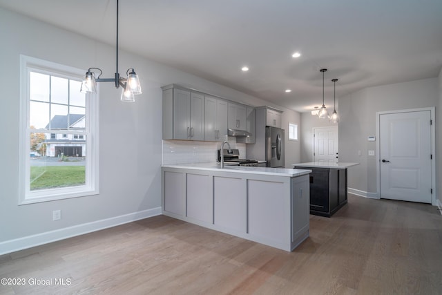 16 Priddle Ln, Colonie, NY 12110 - kitchen featuring gray cabinetry, stainless steel appliances, light countertops, a chandelier, and light wood-style floors