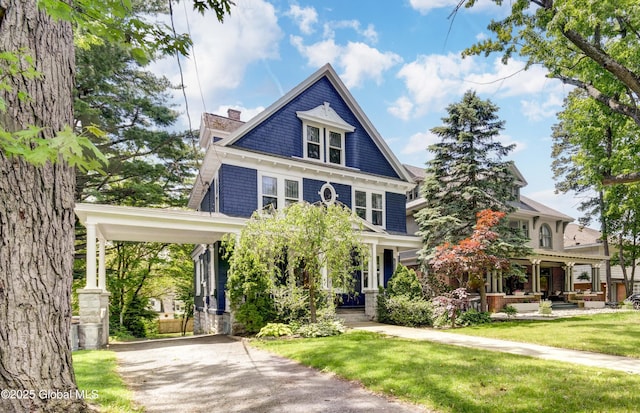 1348 Union St, Schenectady, NY 12308 - traditional style home featuring a front yard, driveway, covered porch, and a chimney