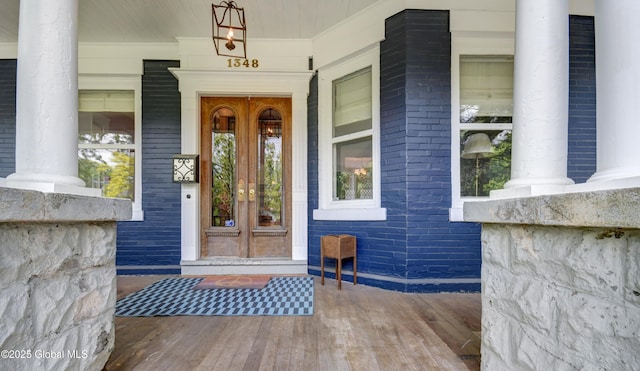 1348 Union St, Schenectady, NY 12308 - property entrance featuring french doors, covered porch, and brick siding
