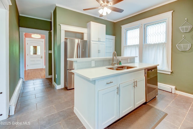 1348 Union St, Schenectady, NY 12308 - kitchen with stainless steel appliances, white cabinetry, ceiling fan, a sink, and light countertops