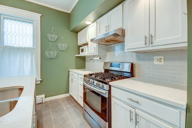 1348 Union St, Schenectady, NY 12308 - kitchen with gas range, under cabinet range hood, white cabinets, light countertops, and backsplash