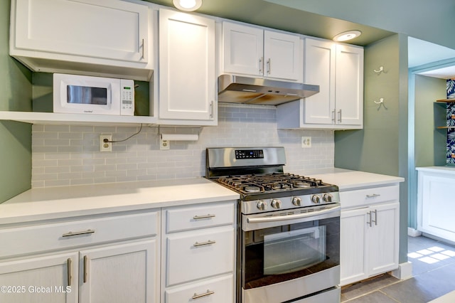 1348 Union St, Schenectady, NY 12308 - kitchen with stainless steel gas range, under cabinet range hood, backsplash, white cabinetry, and light countertops