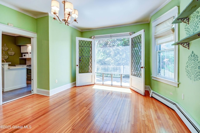 1348 Union St, Schenectady, NY 12308 - unfurnished room featuring a baseboard heating unit, wood-type flooring, a chandelier, plenty of natural light, and crown molding
