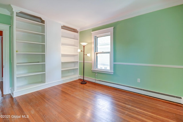 1348 Union St, Schenectady, NY 12308 - spare room with a baseboard radiator, wood-type flooring, built in shelves, and crown molding