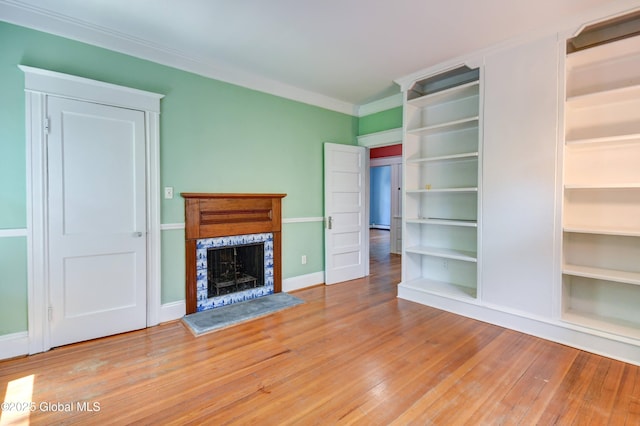 1348 Union St, Schenectady, NY 12308 - unfurnished living room featuring a fireplace with raised hearth, wood finished floors, baseboards, and ornamental molding