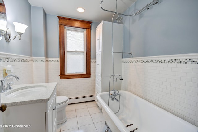 1348 Union St, Schenectady, NY 12308 - bathroom featuring a baseboard heating unit, vanity, tile patterned floors, a wainscoted wall, and toilet