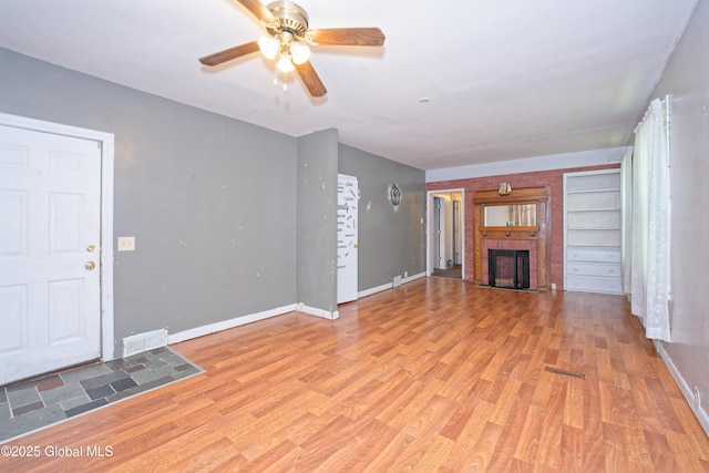 1526 6th Ave, Watervliet, NY 12189 - unfurnished living room with ceiling fan, wood finished floors, and a fireplace