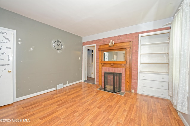 1526 6th Ave, Watervliet, NY 12189 - unfurnished living room featuring a fireplace, wood finished floors, and built in shelves