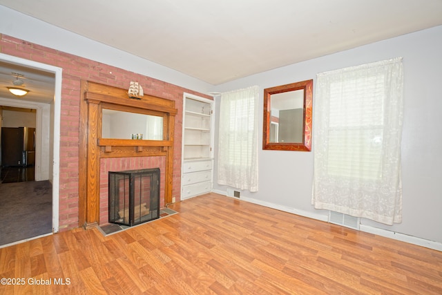 1526 6th Ave, Watervliet, NY 12189 - unfurnished living room with wood finished floors and a fireplace