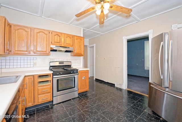 1526 6th Ave, Watervliet, NY 12189 - kitchen with stainless steel appliances, under cabinet range hood, ceiling fan, light countertops, and backsplash
