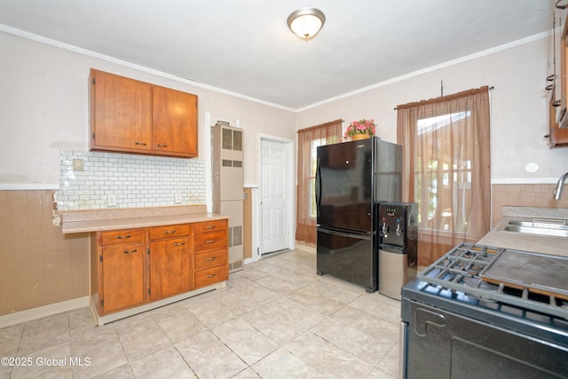 1526 6th Ave, Watervliet, NY 12189 - kitchen with black appliances, light countertops, brown cabinetry, backsplash, and crown molding