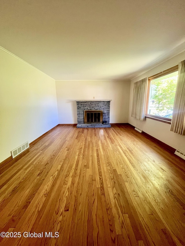 19 Lillian Dr, Glenville, NY 12302 - unfurnished living room featuring a fireplace, wood finished floors, baseboards, and crown molding