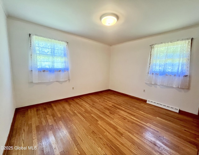 19 Lillian Dr, Glenville, NY 12302 - empty room featuring ornamental molding, a baseboard heating unit, wood finished floors, and baseboards