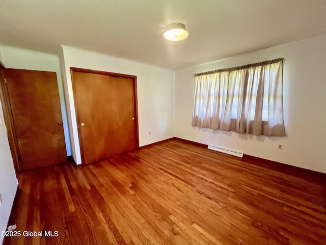 19 Lillian Dr, Glenville, NY 12302 - unfurnished bedroom featuring wood finished floors, a closet, and a baseboard heating unit