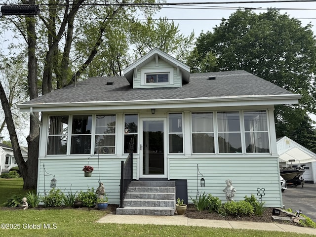 8 Hackett St, Bethlehem, NY 12158 - bungalow-style house featuring entry steps, a shingled roof, and a sunroom