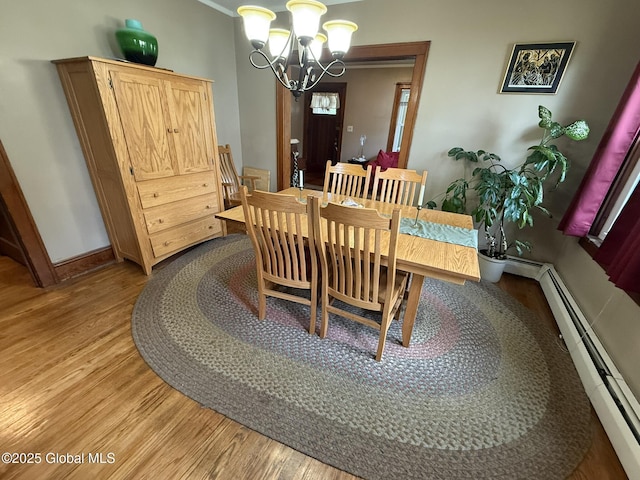 8 Hackett St, Bethlehem, NY 12158 - dining room featuring light wood finished floors, a baseboard heating unit, a chandelier, and baseboards