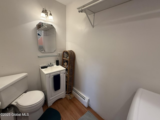 8 Hackett St, Bethlehem, NY 12158 - half bathroom with a baseboard heating unit, wood finished floors, toilet, and vanity