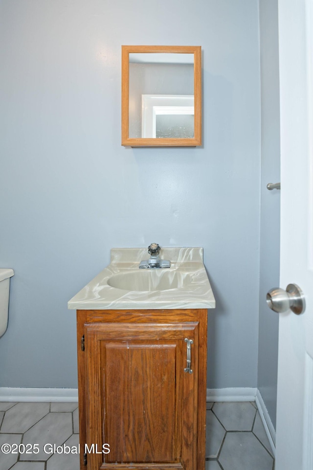 1123 Ardsley Rd, Schenectady, NY 12308 - half bathroom with vanity, tile patterned floors, baseboards, and toilet