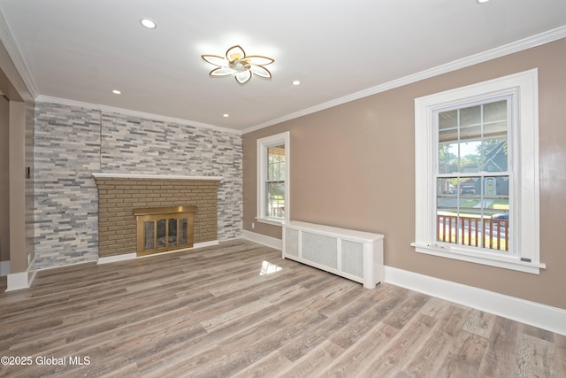1123 Ardsley Rd, Schenectady, NY 12308 - unfurnished living room with radiator, plenty of natural light, crown molding, wood finished floors, and baseboards