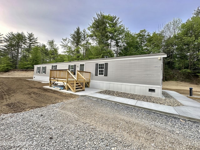 6041 Rte 9n, Hadley, NY 12835 - manufactured / mobile home with a wooden deck and view of wooded area