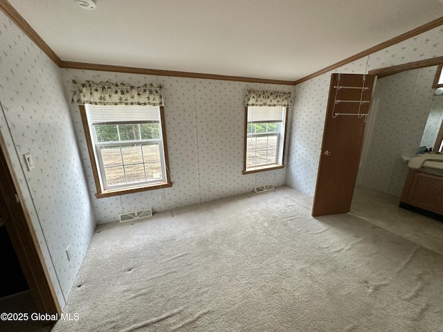 6041 Rte 9n, Hadley, NY 12835 - unfurnished bedroom featuring ornamental molding, wallpapered walls, carpet, and multiple windows