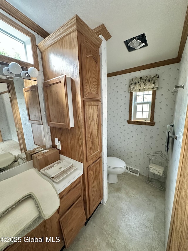 6041 Rte 9n, Hadley, NY 12835 - bathroom featuring toilet, ornamental molding, and wallpapered walls