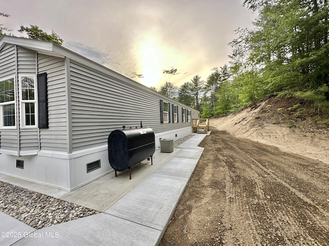 6041 Rte 9n, Hadley, NY 12835 - property exterior at dusk with crawl space, oil tank, and cooling unit