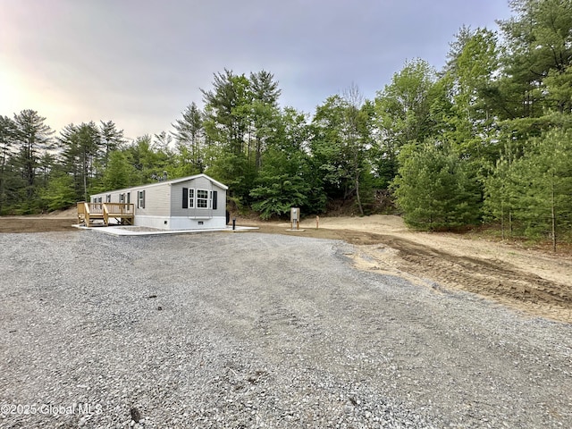 6041 Rte 9n, Hadley, NY 12835 - manufactured / mobile home featuring gravel driveway and a deck