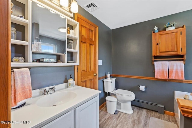 30 Overlook Ct, Claverack, NY 12534 - bathroom featuring a baseboard heating unit, vanity, wood finished floors, toilet, and baseboards