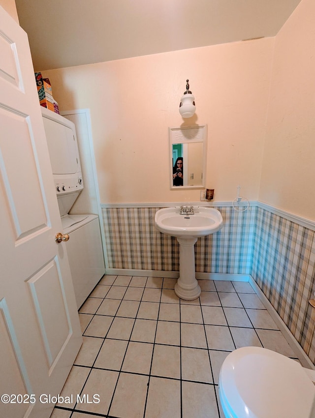 258 Middle Rd, Crown Point, NY 12928 - bathroom featuring estacked washer and dryer, wainscoting, wallpapered walls, toilet, and tile patterned floors