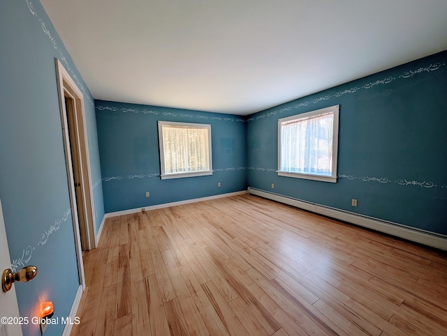 258 Middle Rd, Crown Point, NY 12928 - unfurnished bedroom featuring a baseboard radiator, wood finished floors, and baseboards