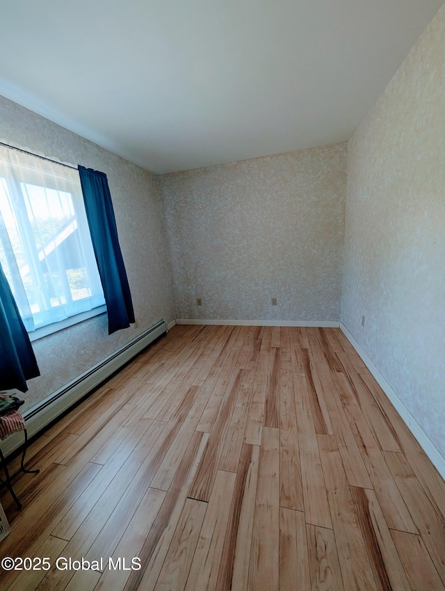 258 Middle Rd, Crown Point, NY 12928 - empty room featuring light wood-style floors, baseboards, and a baseboard radiator