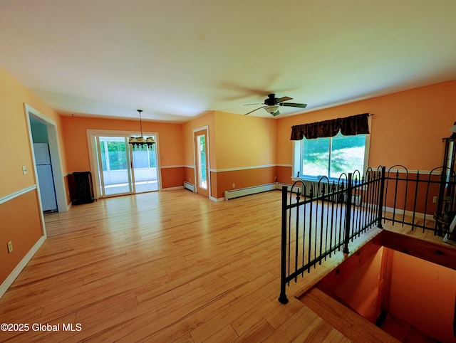258 Middle Rd, Crown Point, NY 12928 - empty room featuring a baseboard heating unit, light wood-style flooring, baseboards, and ceiling fan
