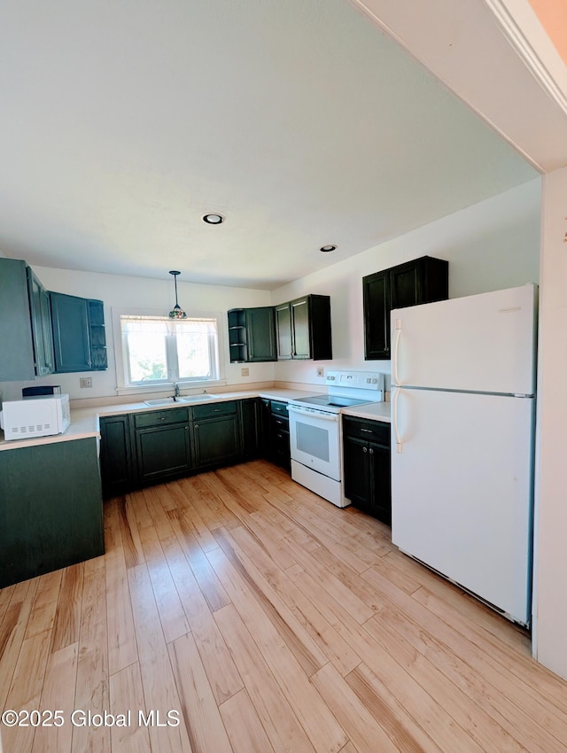 258 Middle Rd, Crown Point, NY 12928 - kitchen with white appliances, light countertops, light wood-type flooring, a sink, and pendant lighting