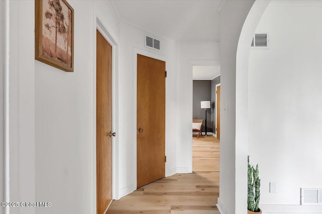 55 Fairview Ave, Hudson, NY 12534 - hallway with light wood-style flooring, arched walkways, and baseboards